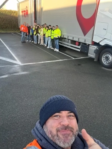 Groupe d’étudiants en gilets haute visibilité devant un camion du groupe Coué TRM lors d’une visite transport routier
