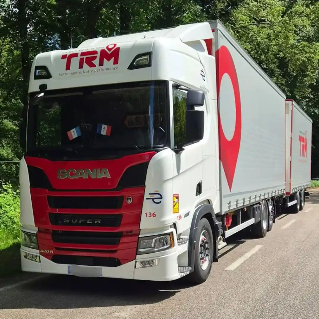 groupe-coue-trm-camion-remorque-scania-web-v2 Ensemble camion remorque Scania aux couleurs du Groupe Coué TRM circulant en forêt pour activité de transport routier grand volume