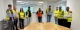Élèves en CAP CRM en visite au sein du Groupe Coué TRM, réunis dans une salle de réunion en gilets haute visibilité